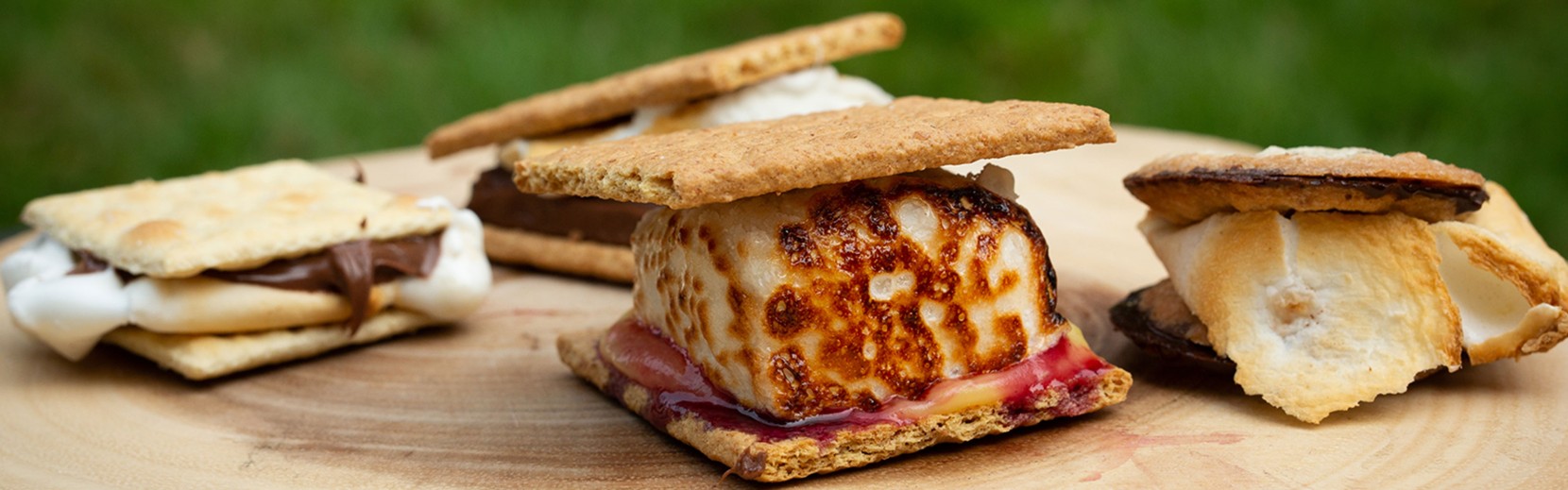 Wooden board with various s'mores.