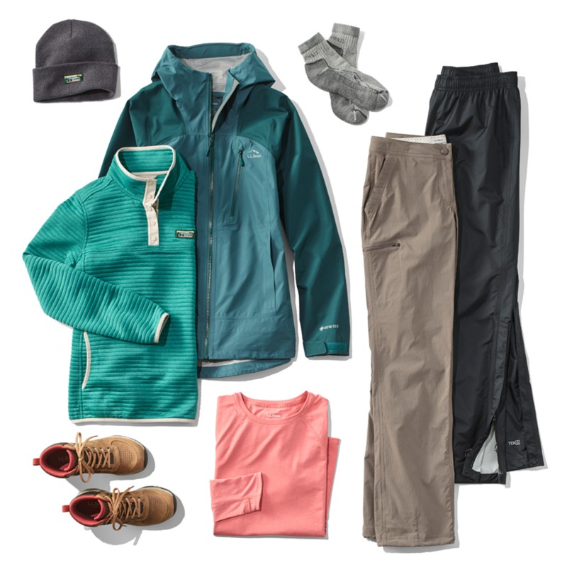 A laydown of clothing needed for hiking in rainy weather.