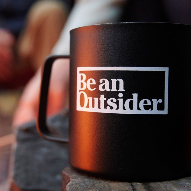 Mug with Be an Outsider logo.