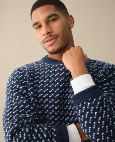 A man waist-up wearing a Ragg Wool Sweater.