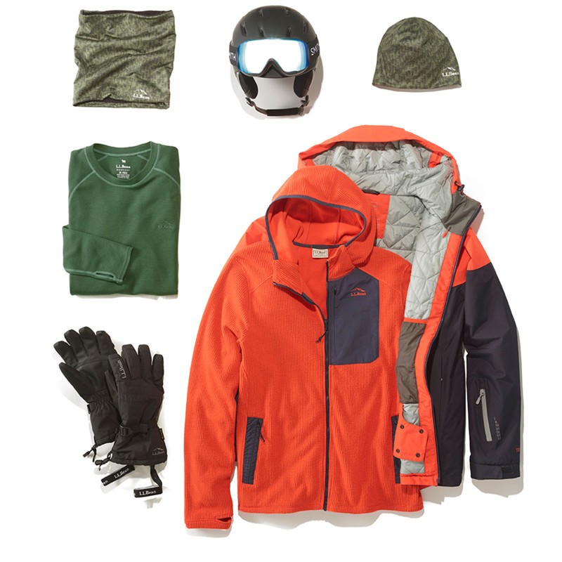 A laydown of clothing needed for alpine skiing.