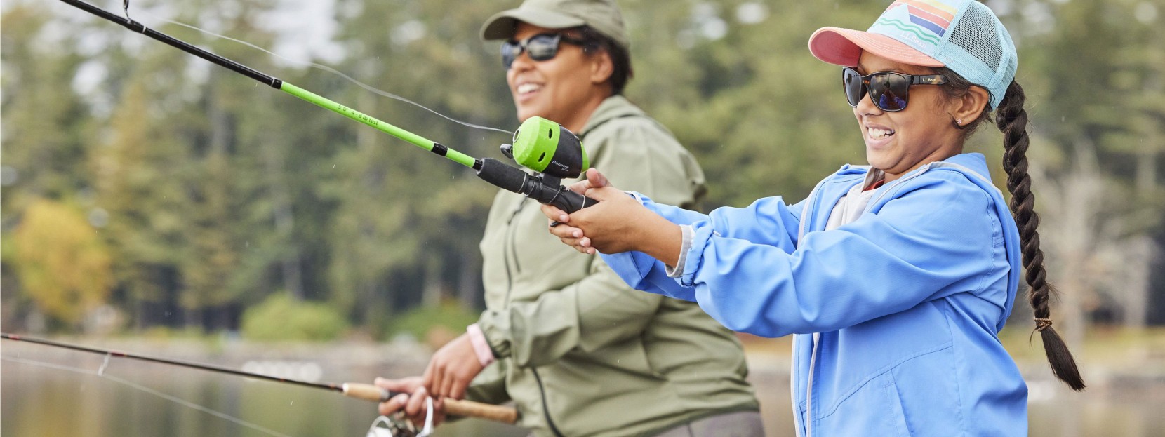 A mom and daughter fishing with spin rods.