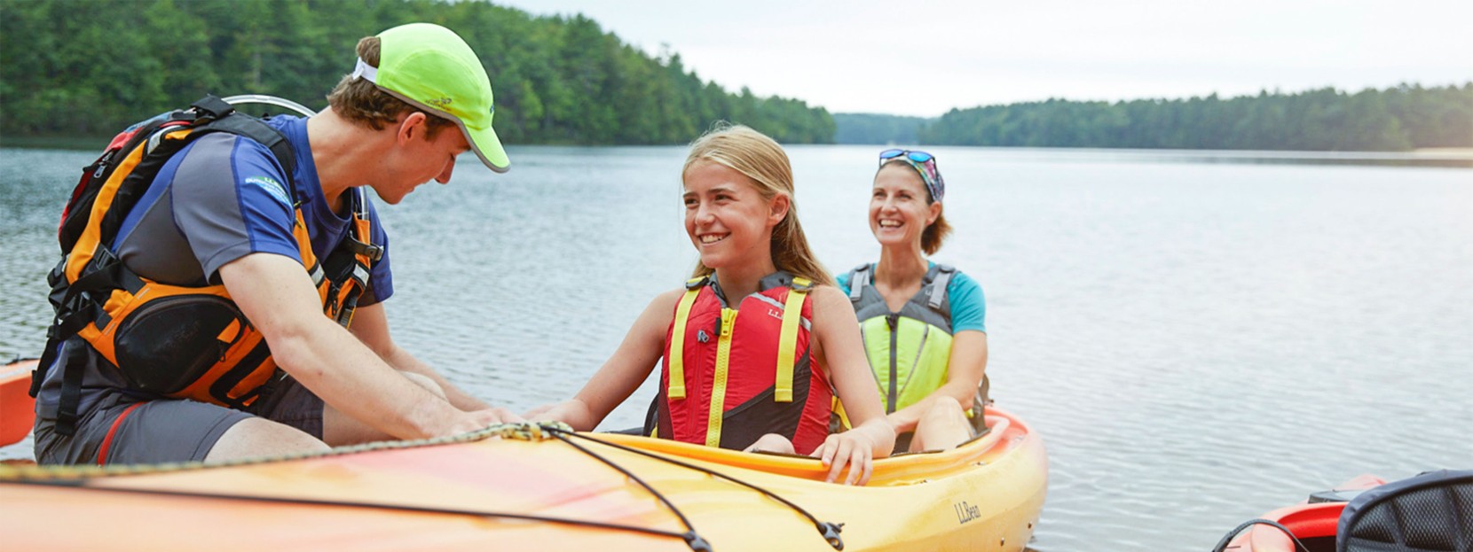 A mother and a daughter learning how to launch a kayak.