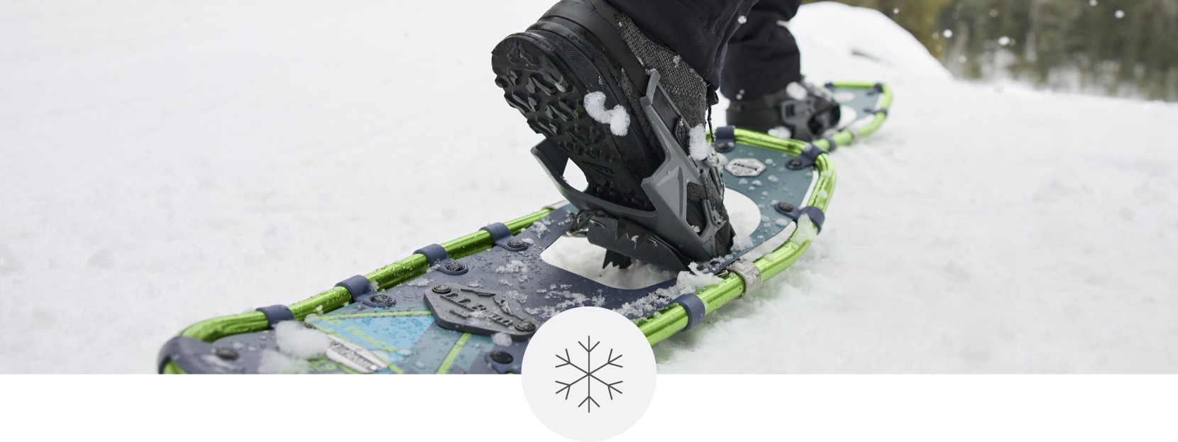 Close-up of feet in snowshoes walking across the snow.