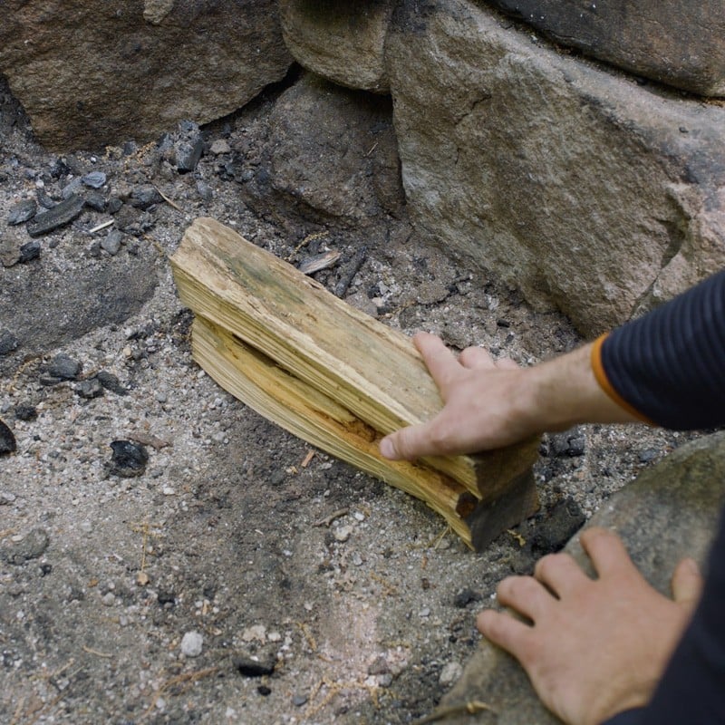 Nate adding a second layer of fuel logs.