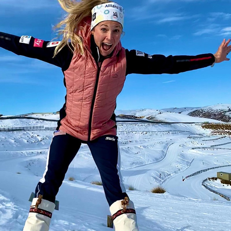 Jessie jumping with snow in the background.