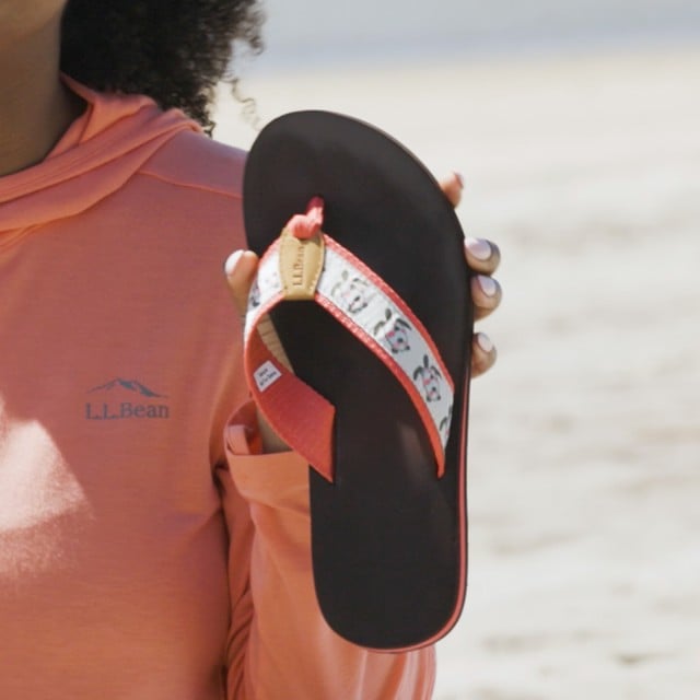 Close-up of Stephanie holding up a flip-flop.