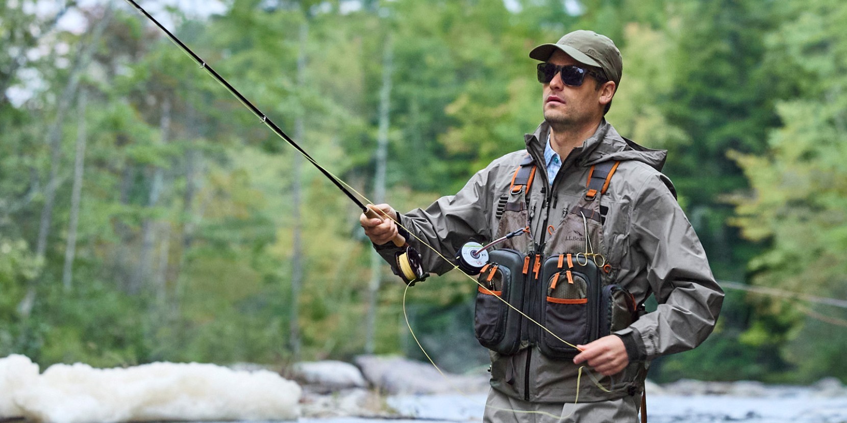 A man fly-fishing in rainy weather.