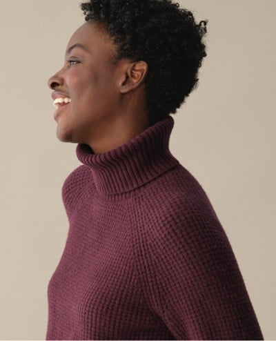 Close-up of a woman wearing a SuperSoft Waffle Sweater.