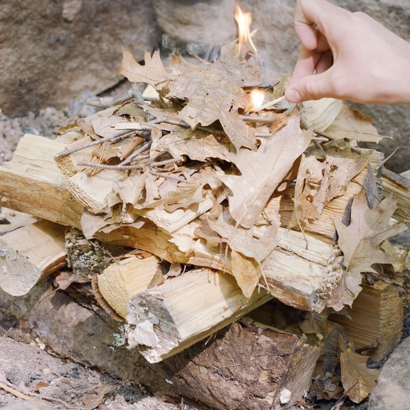 Nate adding a second layer of fuel logs.